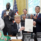 President Donald Trump holds a signed Executive Grant of Clemency for boxer Jack Johnson in the Oval Office of the White House on May 24, 2018, in Washington, D.C.